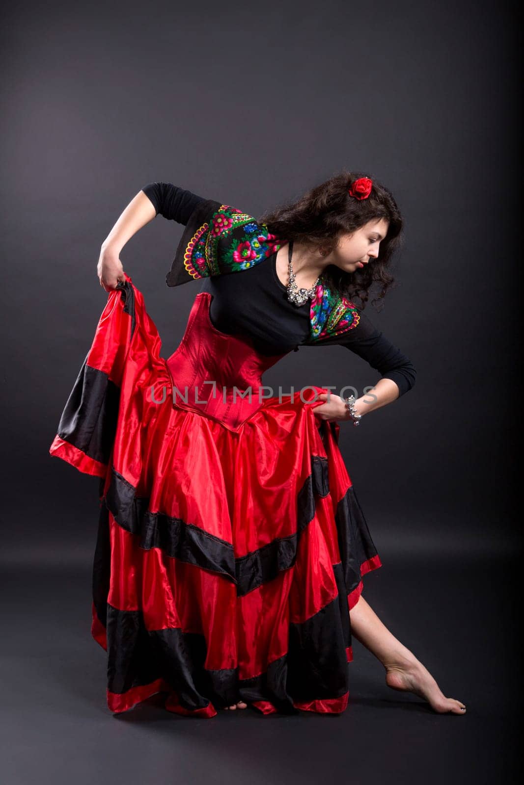 Young woman make step in spanish traditional clothes