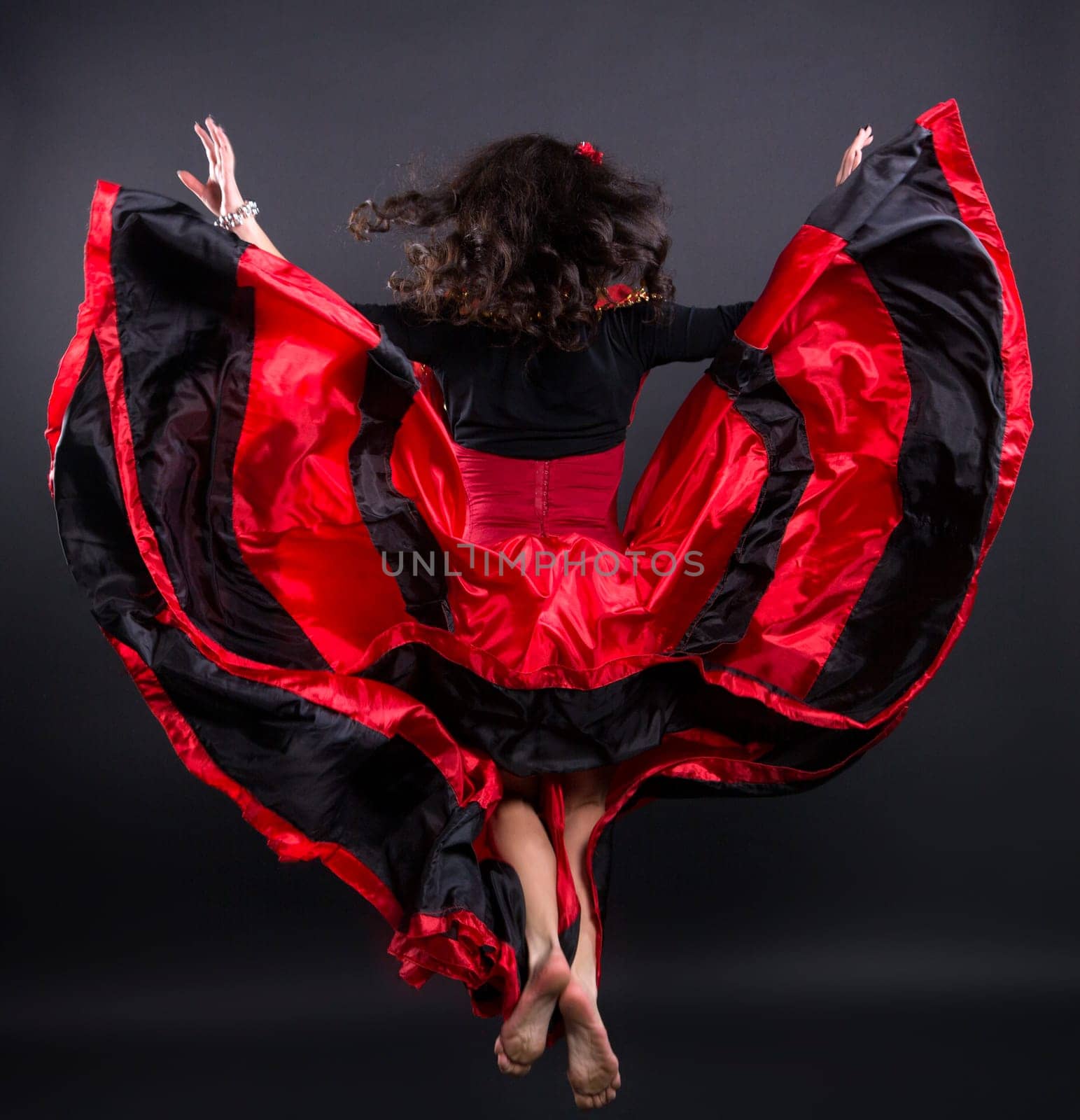 Young romany woman fly in spanish traditional clothes