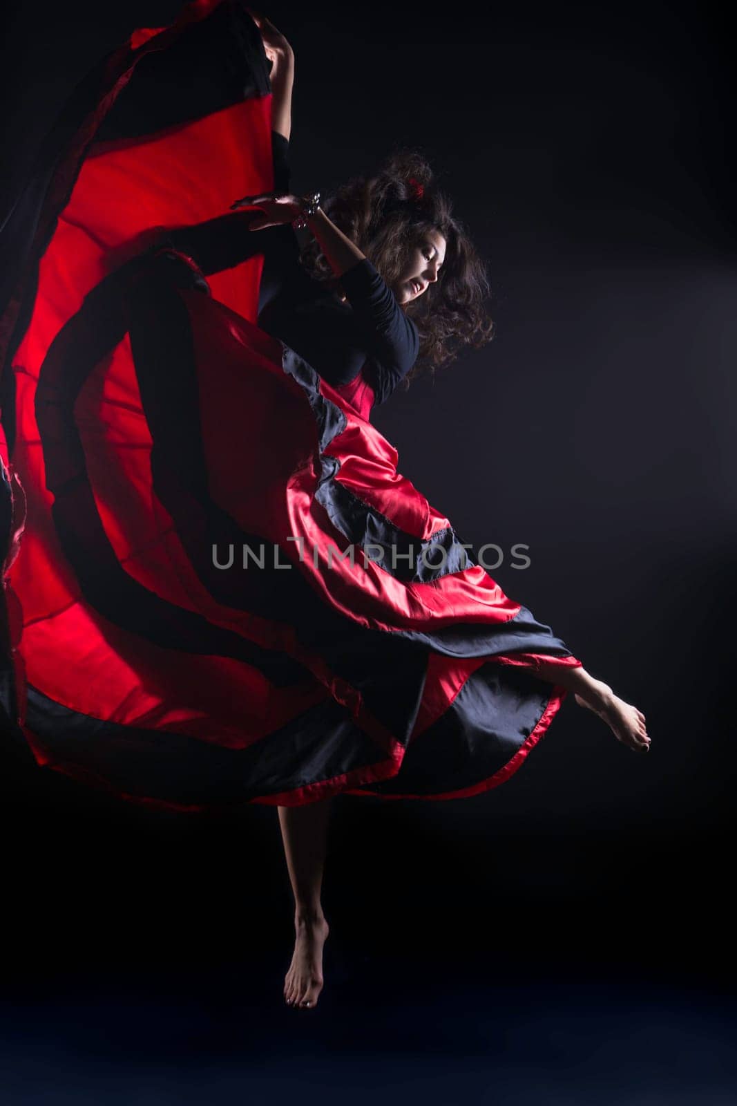 Young woman jump in spanish flamenco with passion