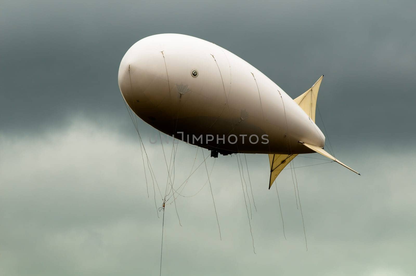 big dirigible flying in the dramatic looking sky