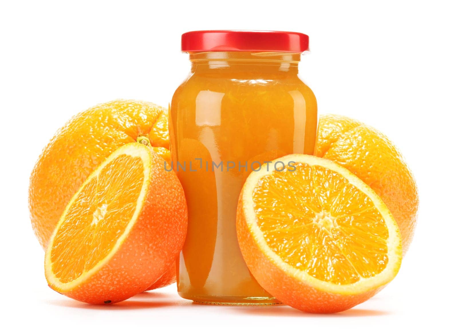Glass and jug of orange juice, jar of jam and fruits. Variety of orange products