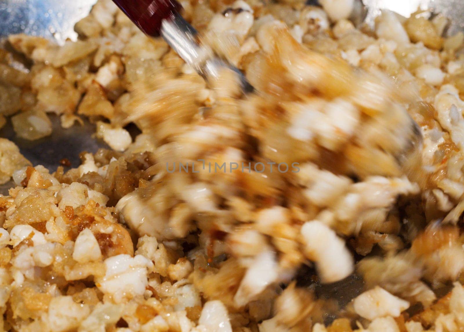 Fried cracklings actively mixed in a pan