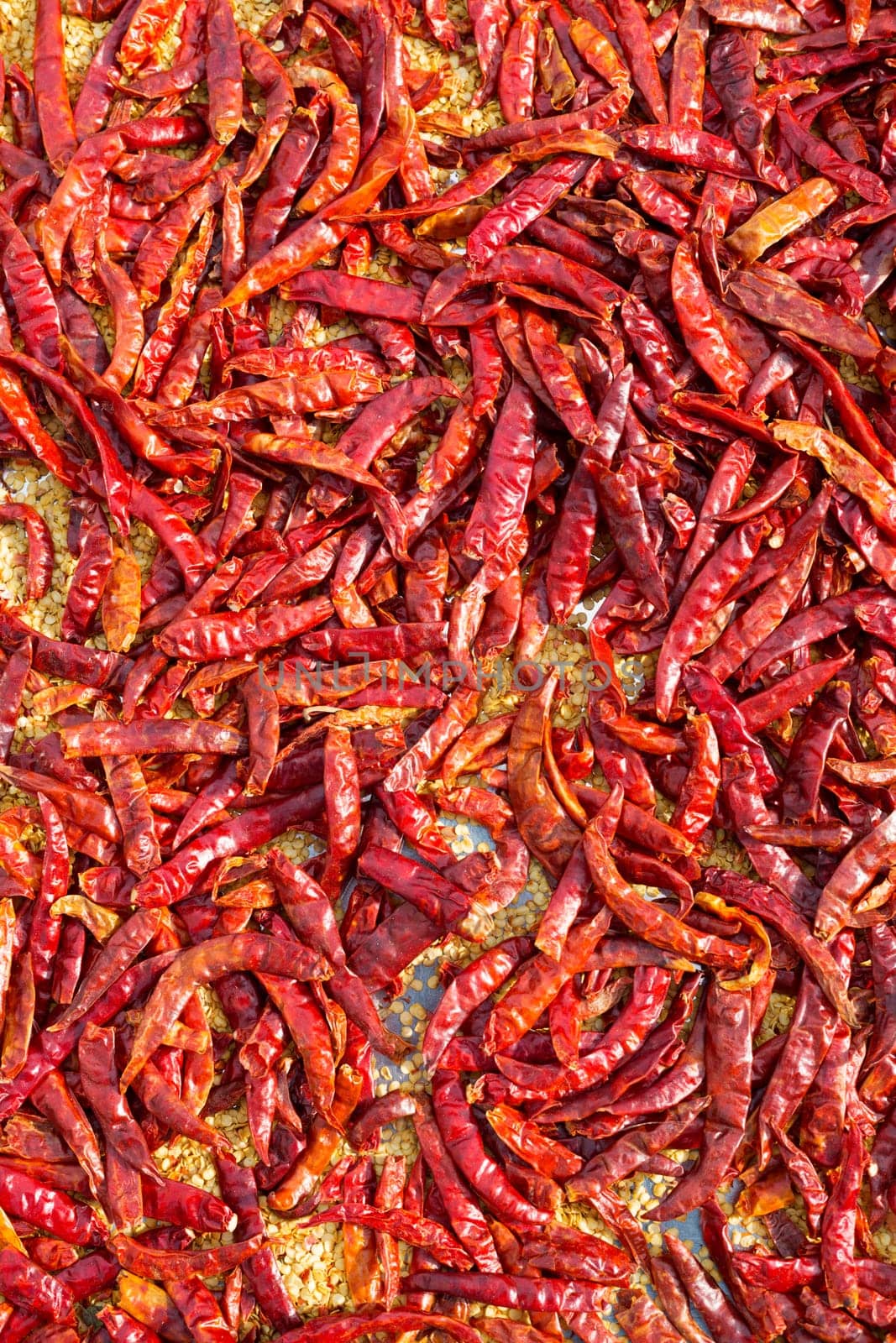 close up of red dried chili flakes food background