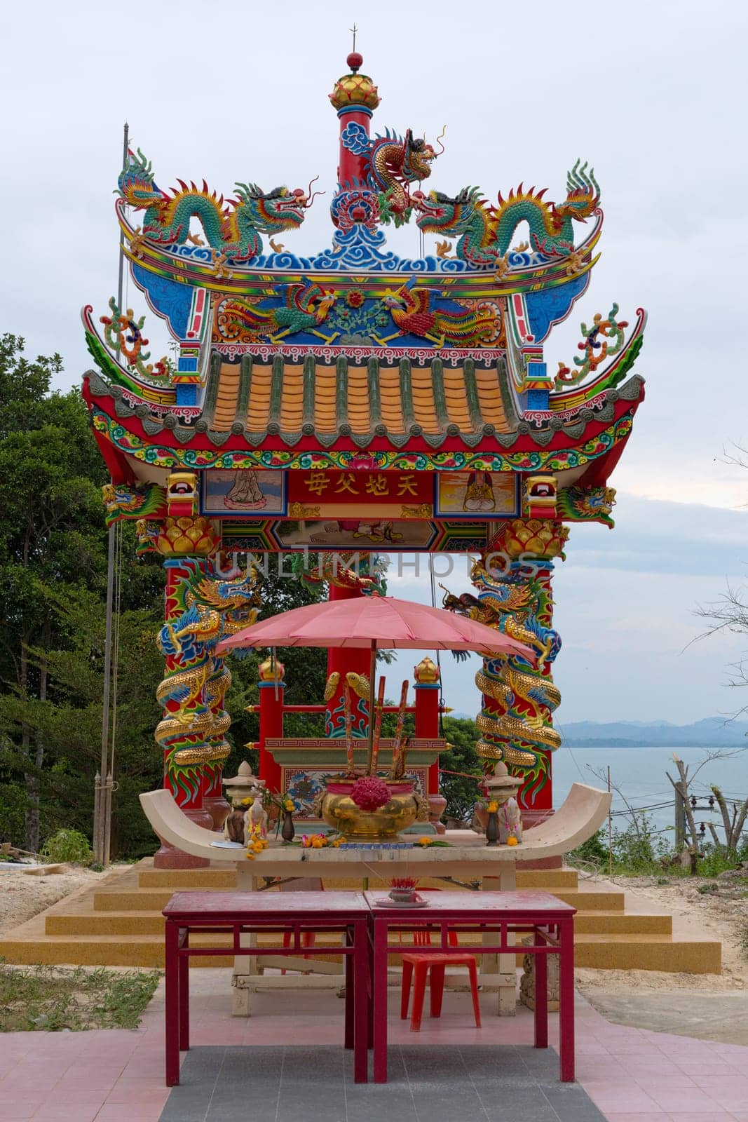 Chinese-style temple in the jungle on a hillside overlooking the sea