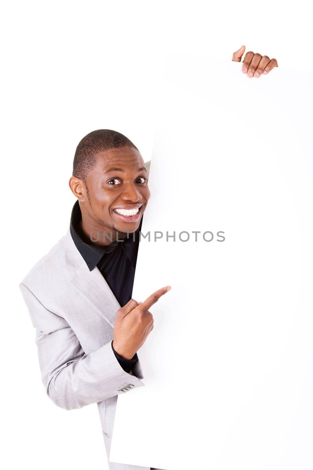 Happy successful businessman holding and showing blank advertisement. Isolated on white.