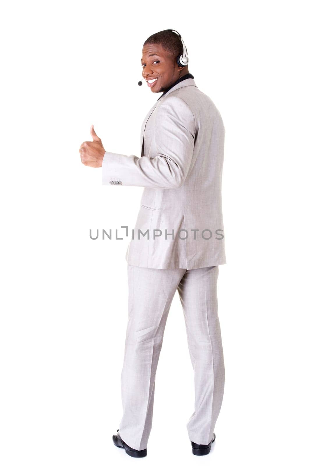 Charming customer service representative with headset on gesturing thumbs up.