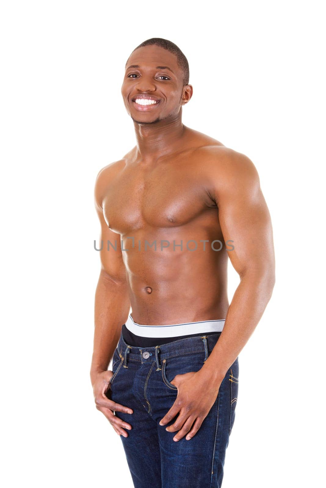 Happy well-built muscular black man in jeans, isolated on white