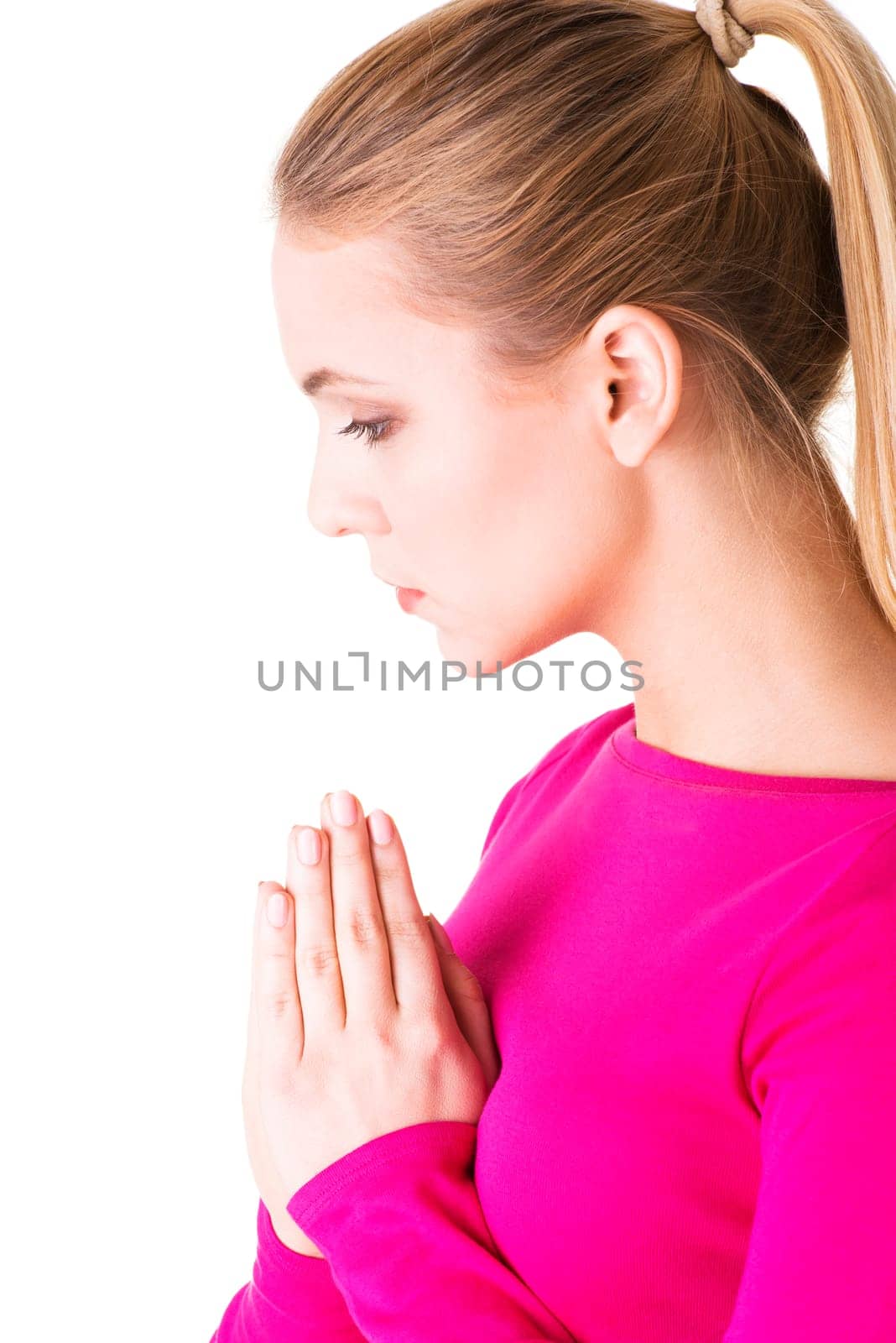 Closeup portrait of a young caucasian woman praying