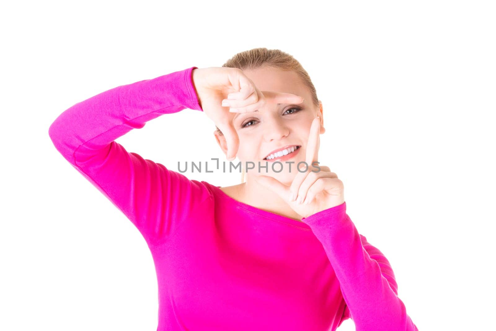 Smiling woman wearing red blouse is showing frame by hands. Happy girl with face in frame of palms. Isolated on white background.