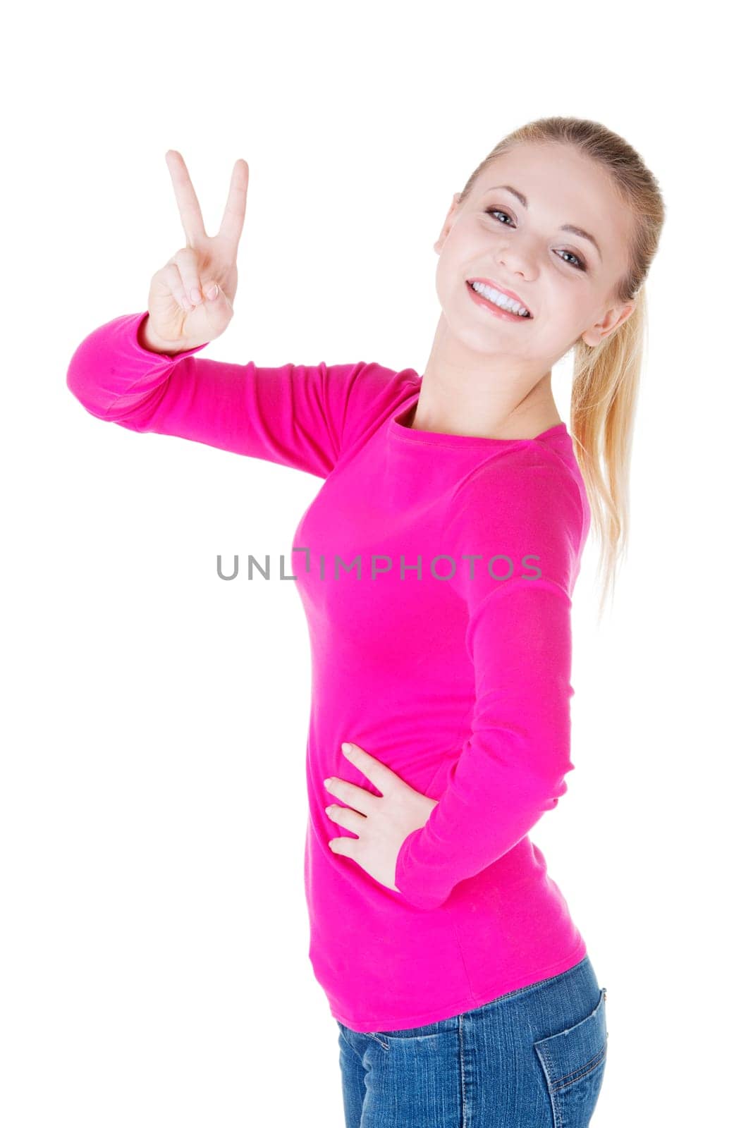 Happy young teenager girl showing victory sign ,isolated on white background