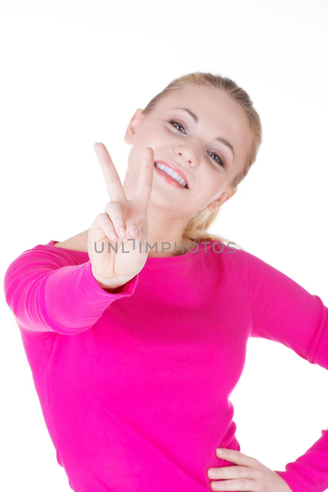 Happy young teenager girl showing victory sign ,isolated on white background