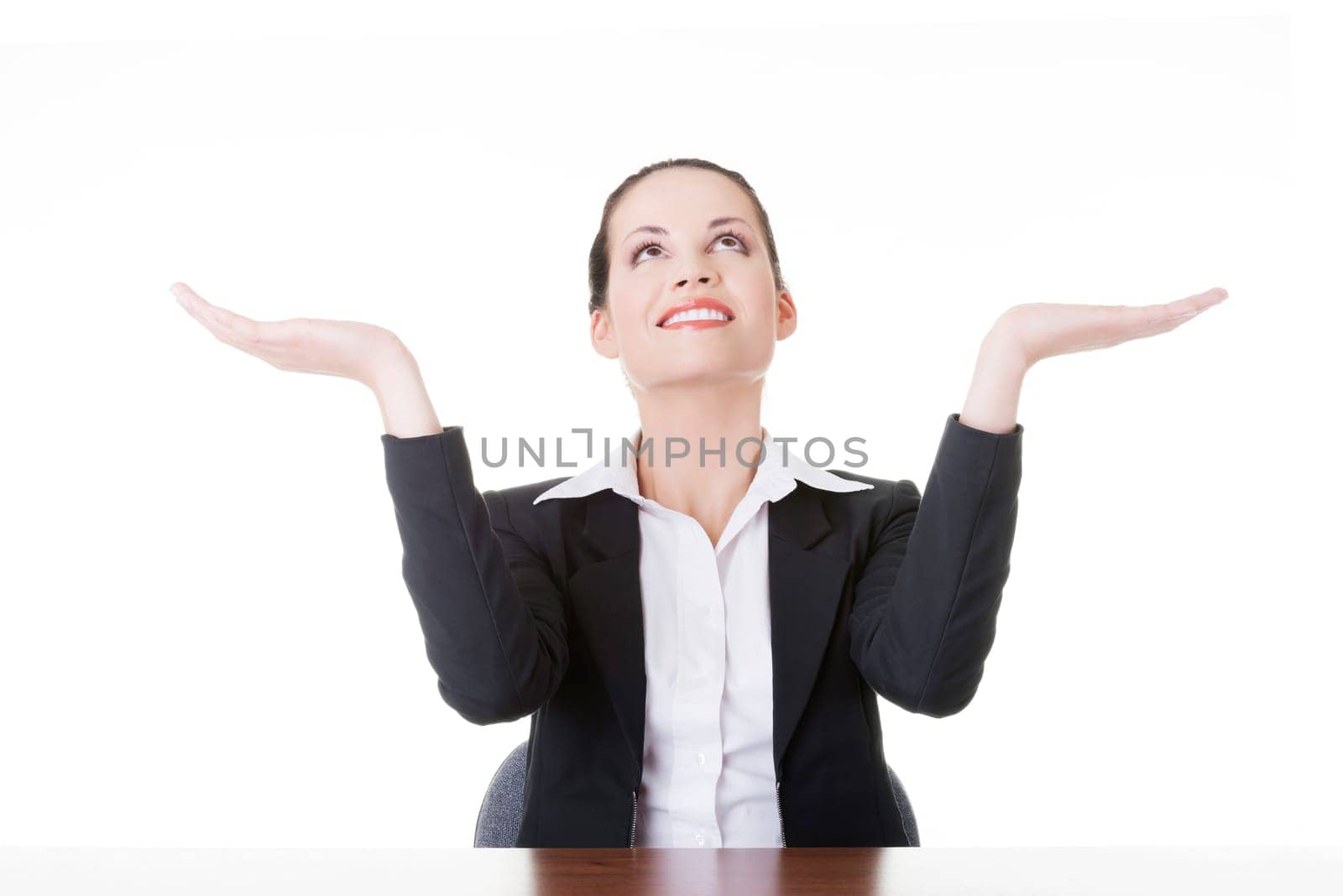 Happy young business woman showing copy space on her palm, isolated on white