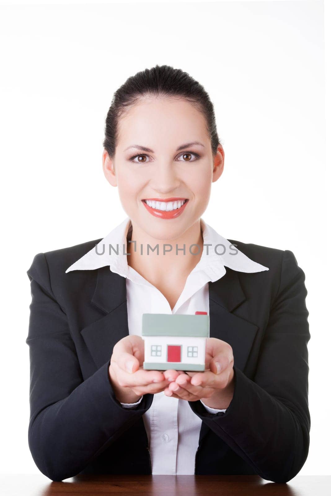 Businesswoman with house model over white - real estate loan or insurance concept