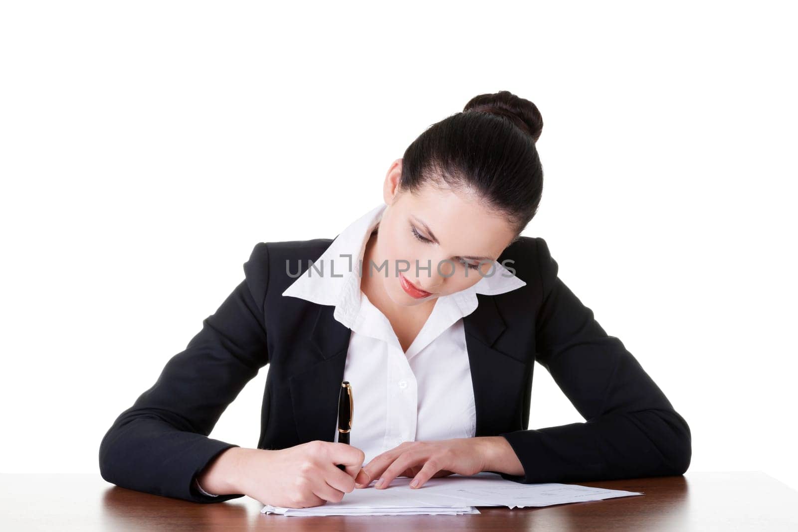 Beautiful attractive corporate lawyer business woman sitting at desk and writing blank paper page, isolated on white background.