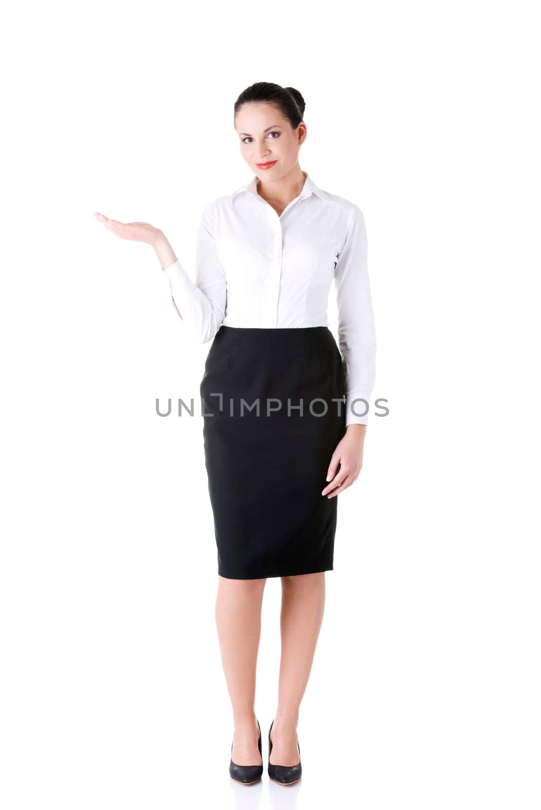 Happy young business woman showing copy space on her palm, isolated on white
