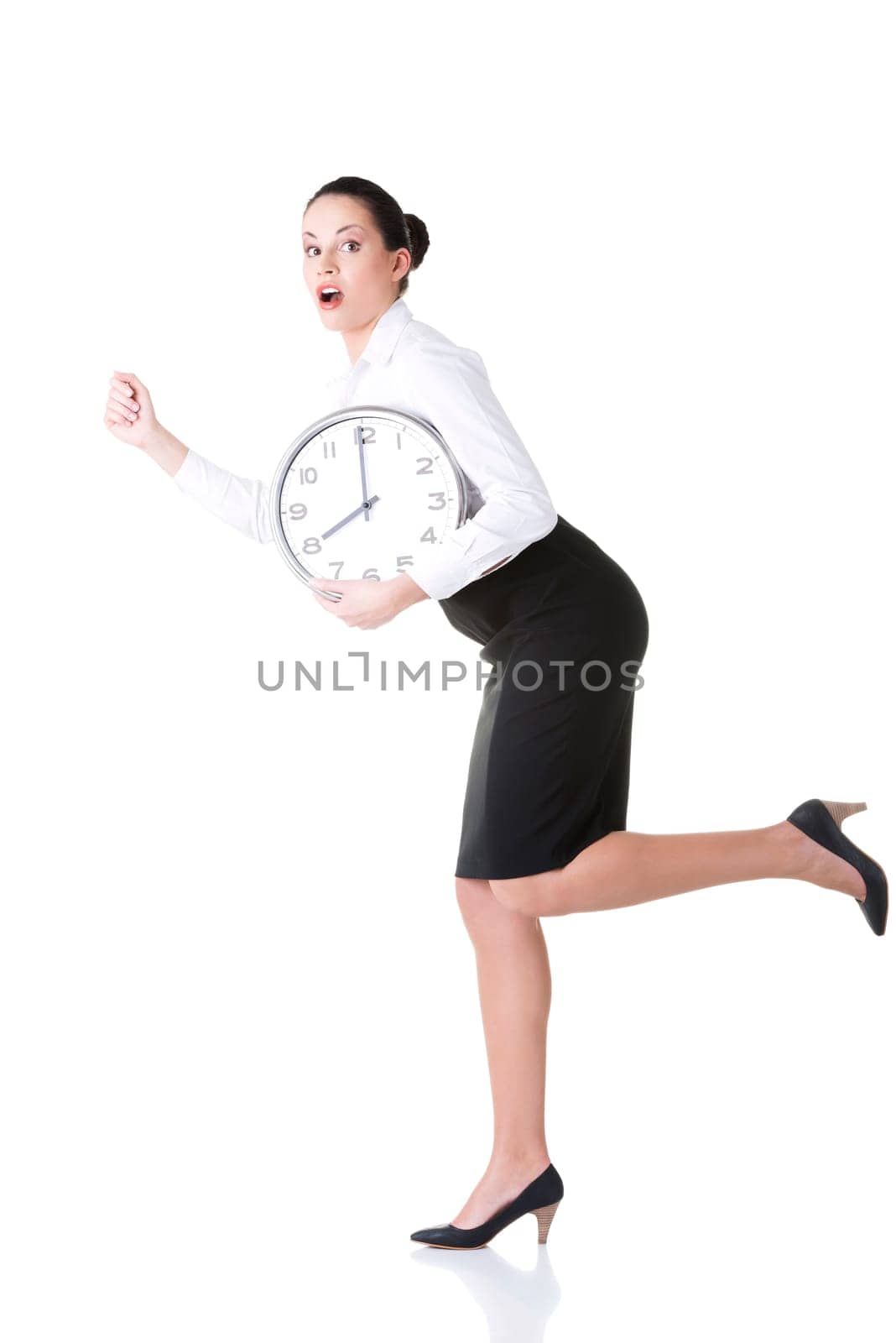 Business woman running late with clock under arm.
