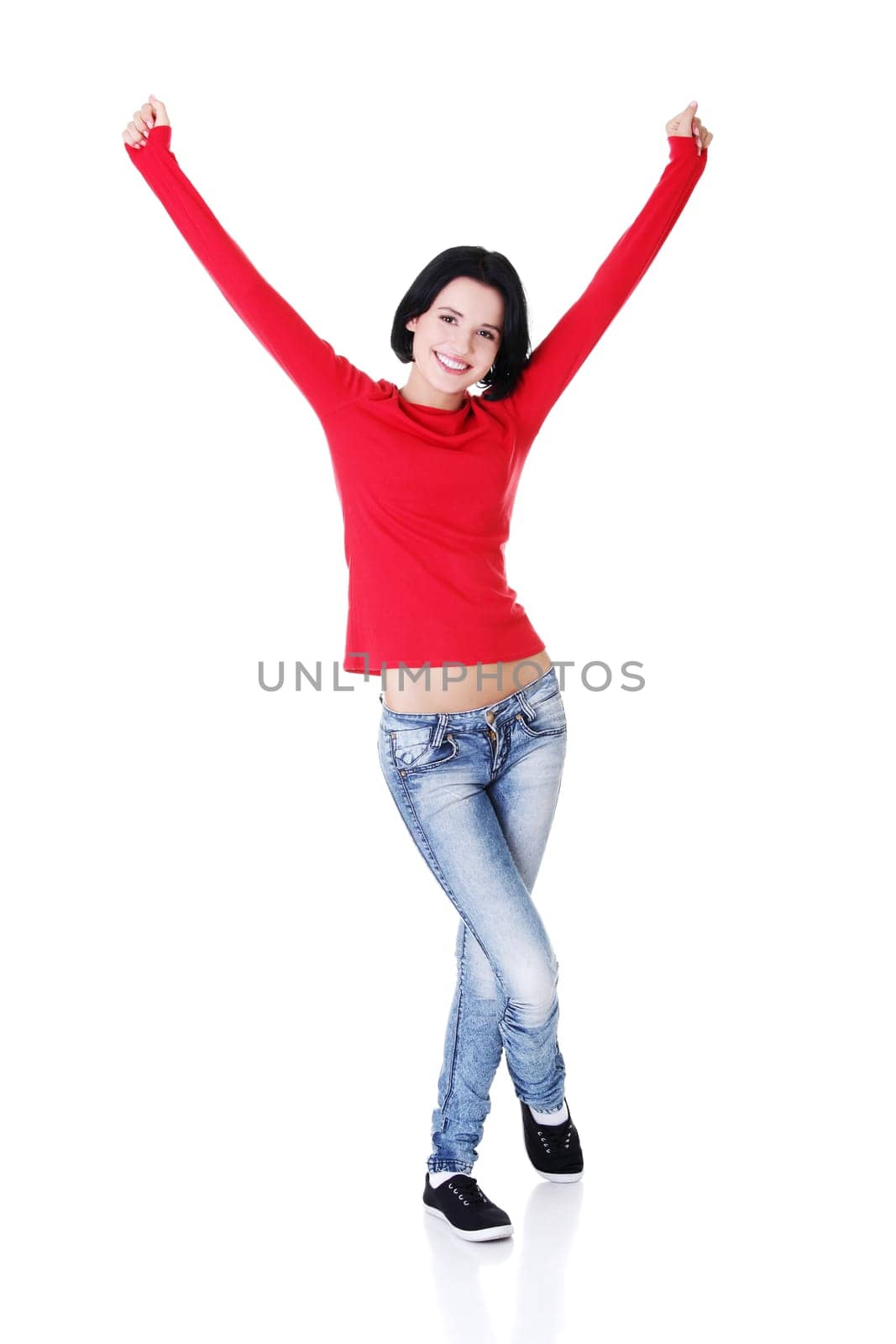 Excited happy young woman with hands up, isolated