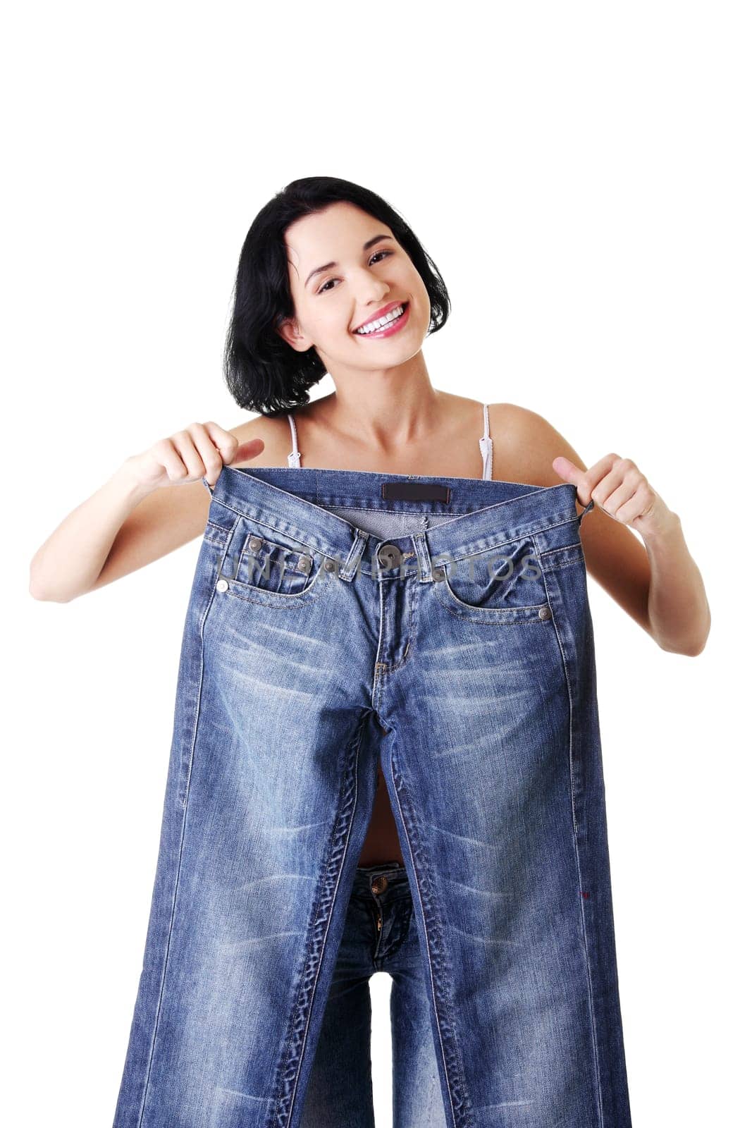 Young happy fit woman with big pants , isolated on white
