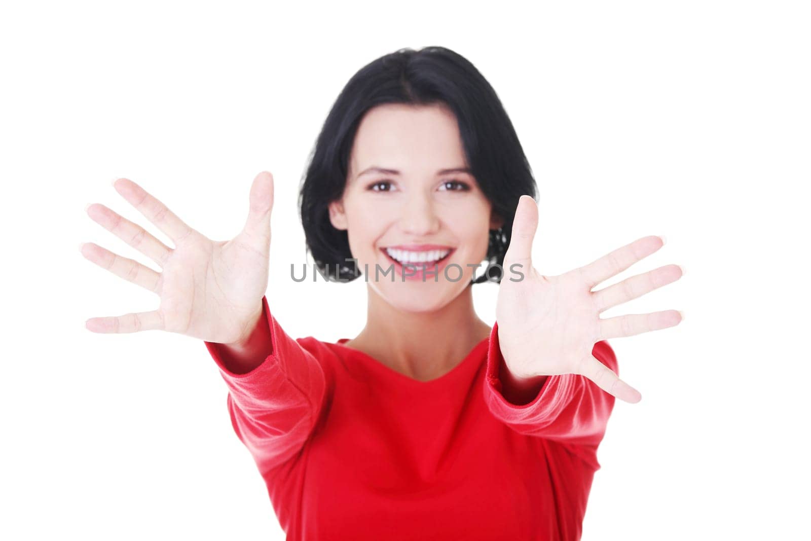 Portrait of excited young woman pointing with both hands towards the camera
