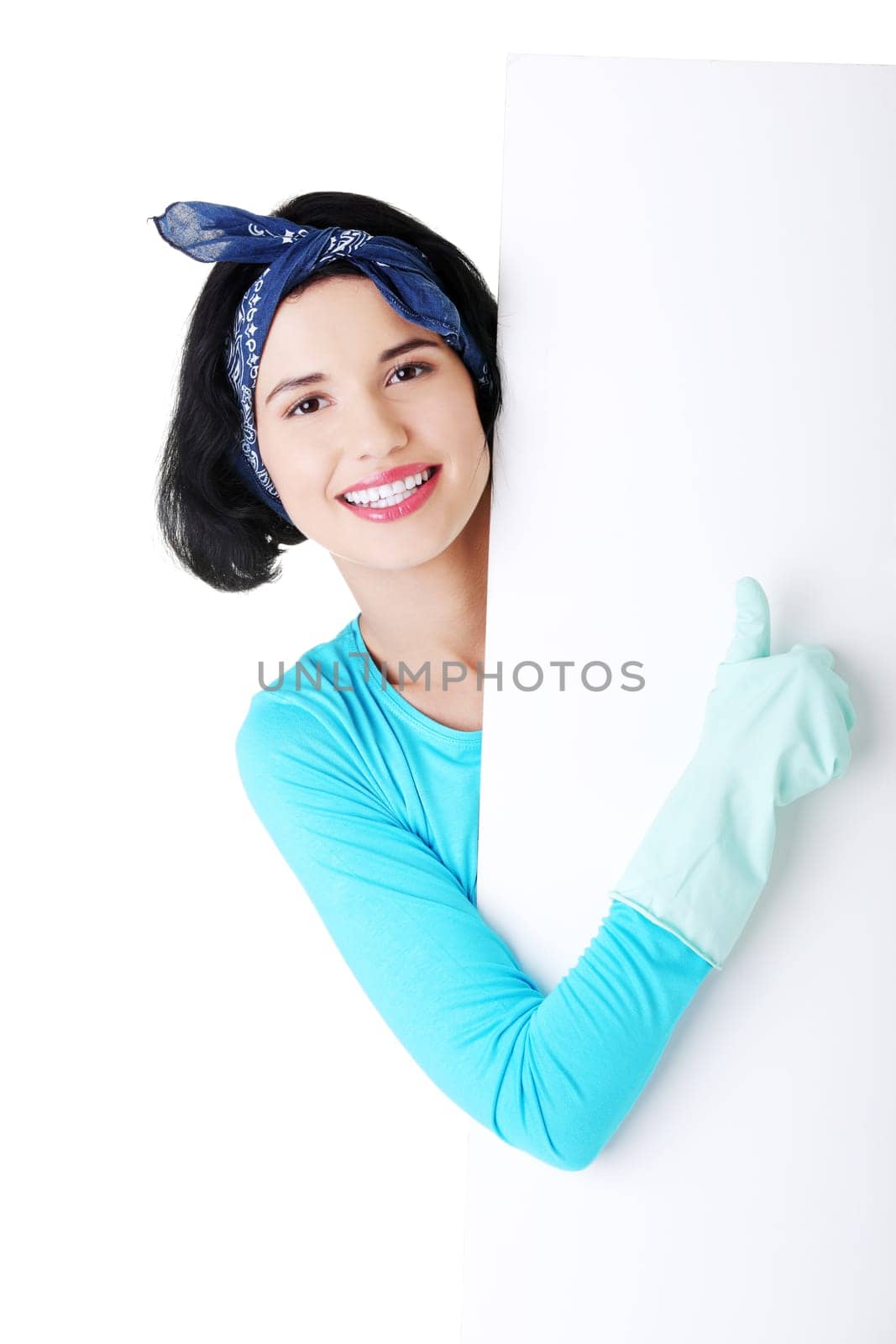 Smiling happy cleaning woman showing blank sign board.