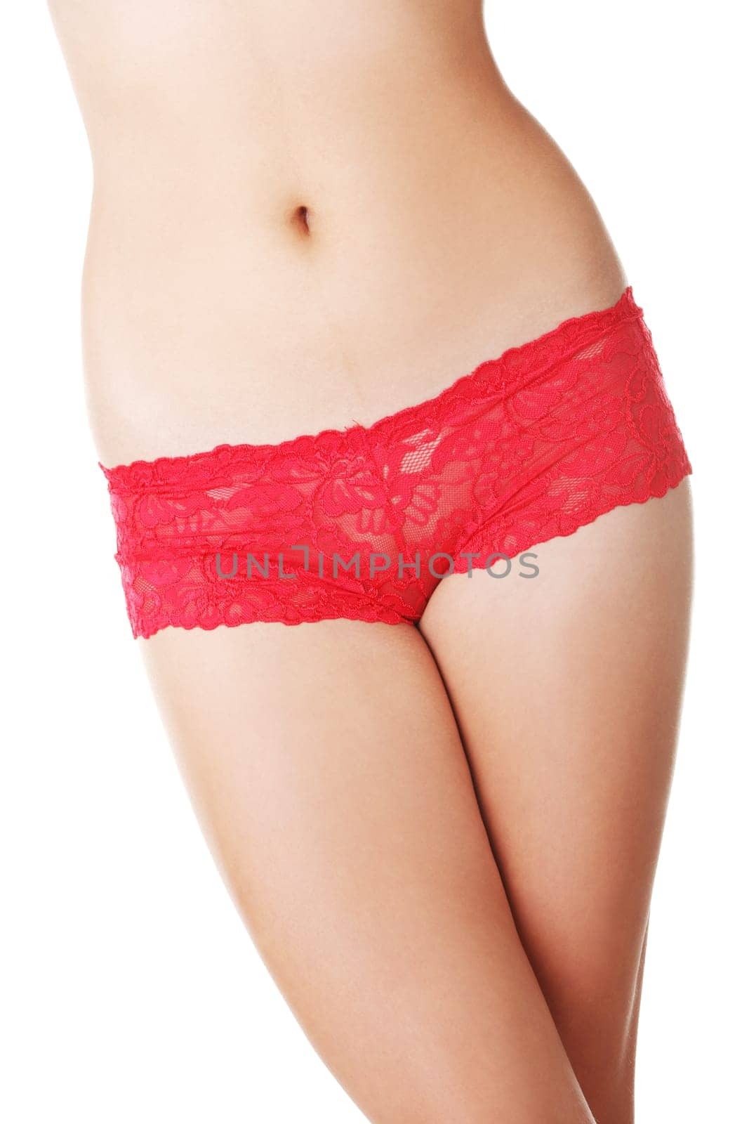 Fit woman body in red panties, isolated on white