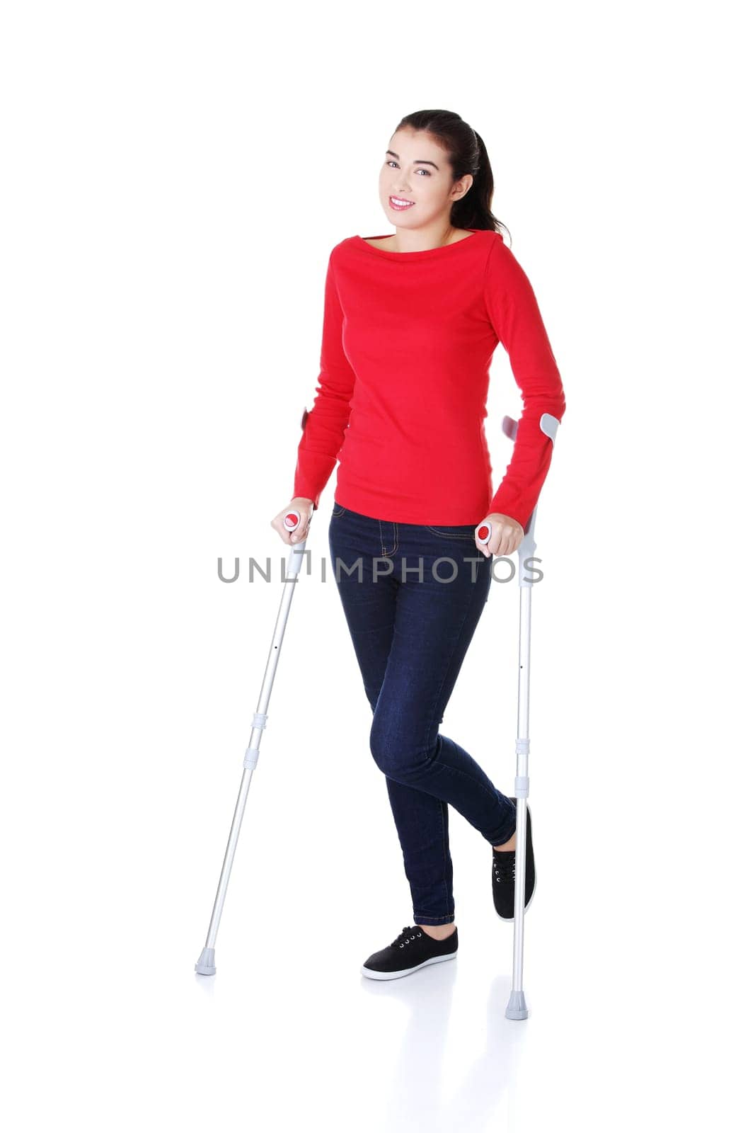 Woman walking with crutches becouse of leg injury