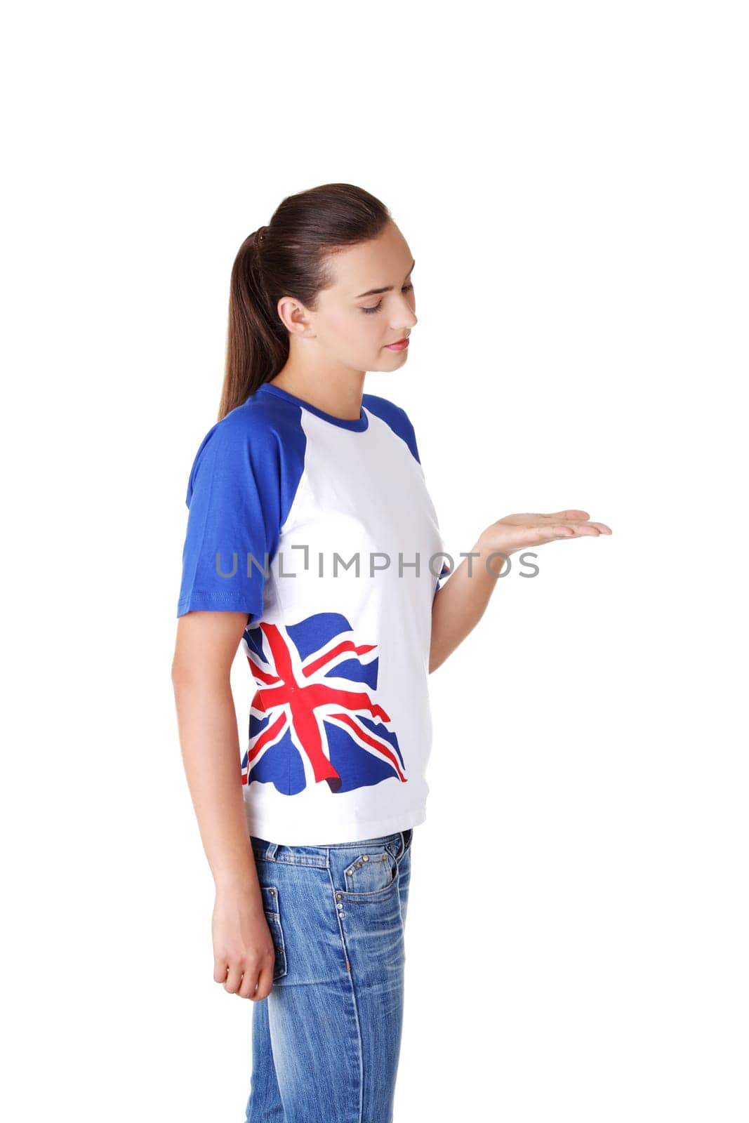Happy , excited young woman in tshirt with british flag showing copy space, isolated on white