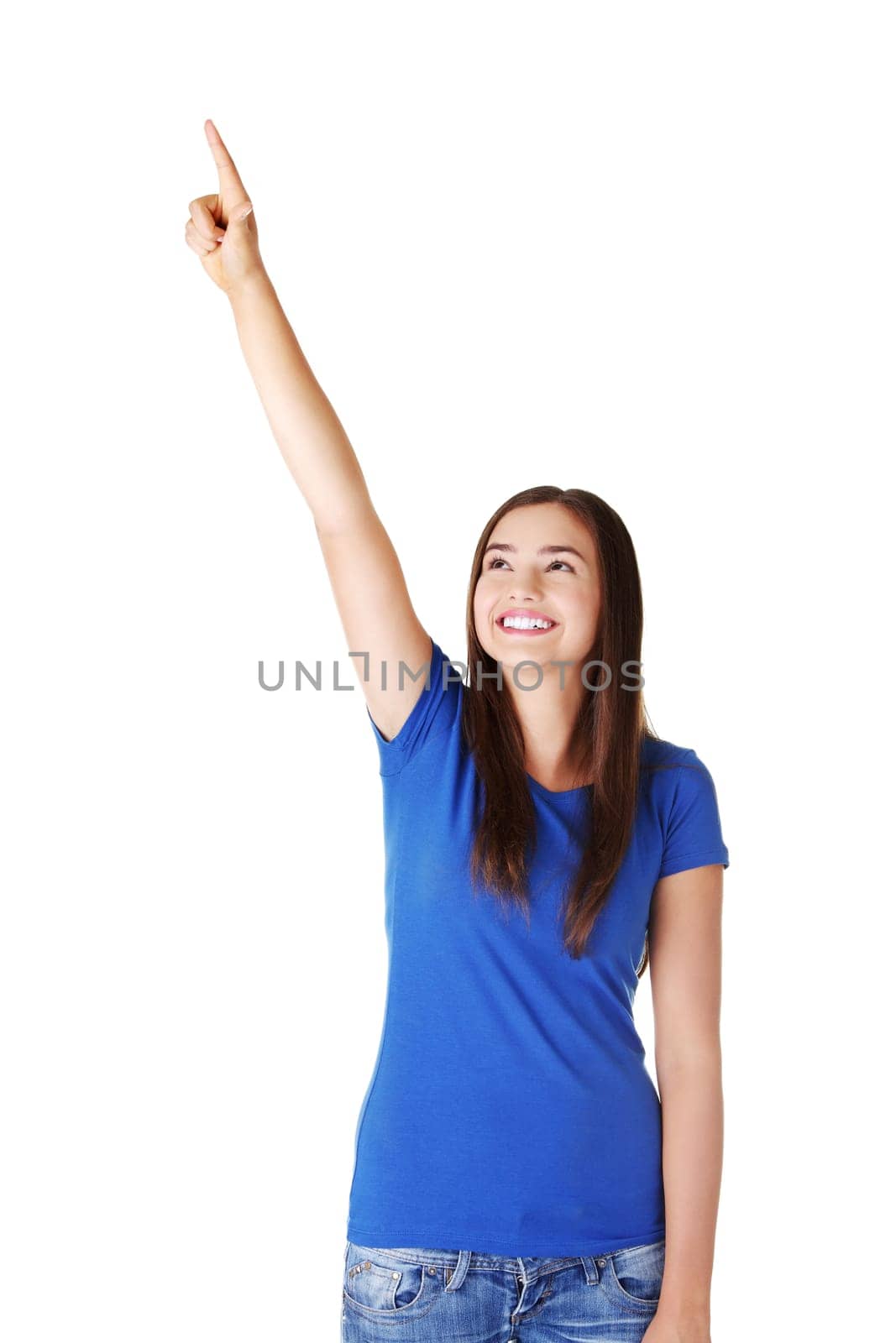 Happy , excited young woman pointing on copy space, isolated on white