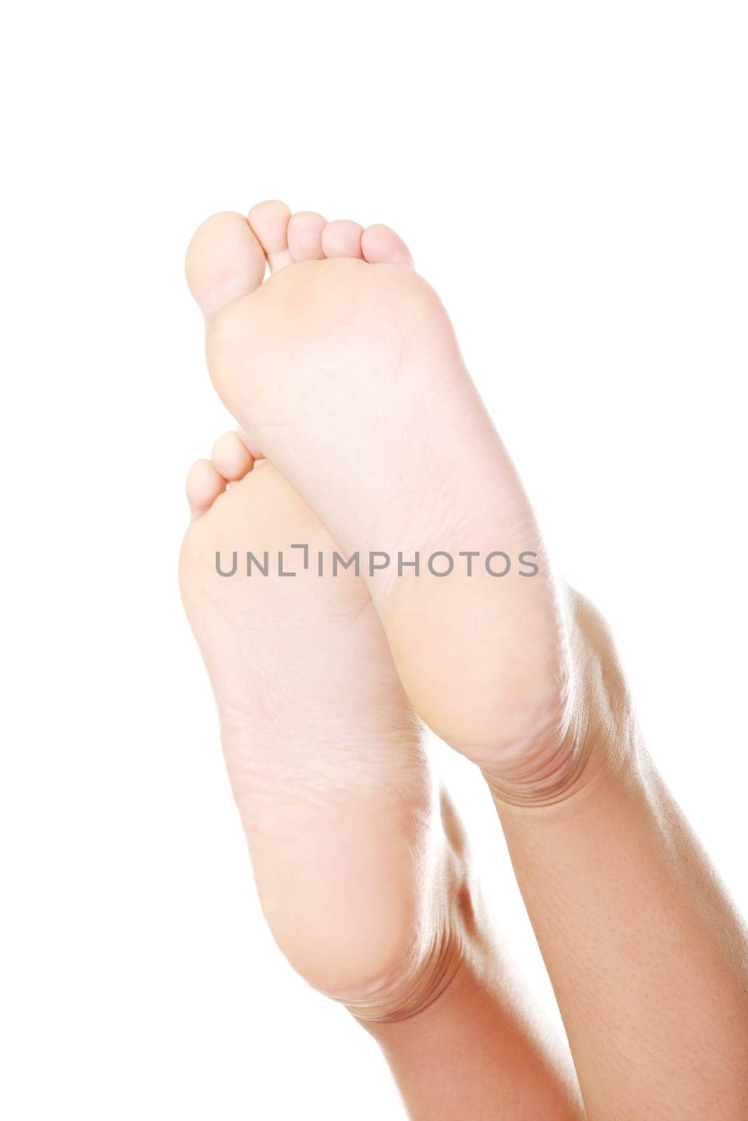 Beautiful female a foot and a heel lifted upwards on a white background