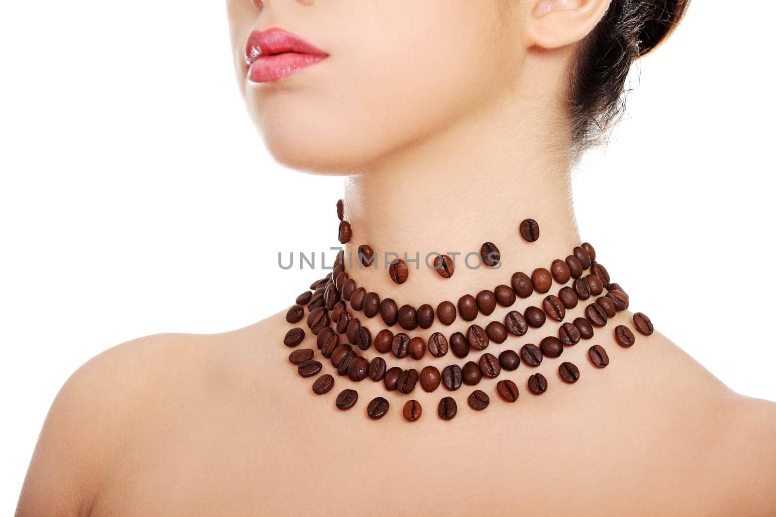 Beautiful elegant young woman with necklace made frome coffee beans, isolated on white
