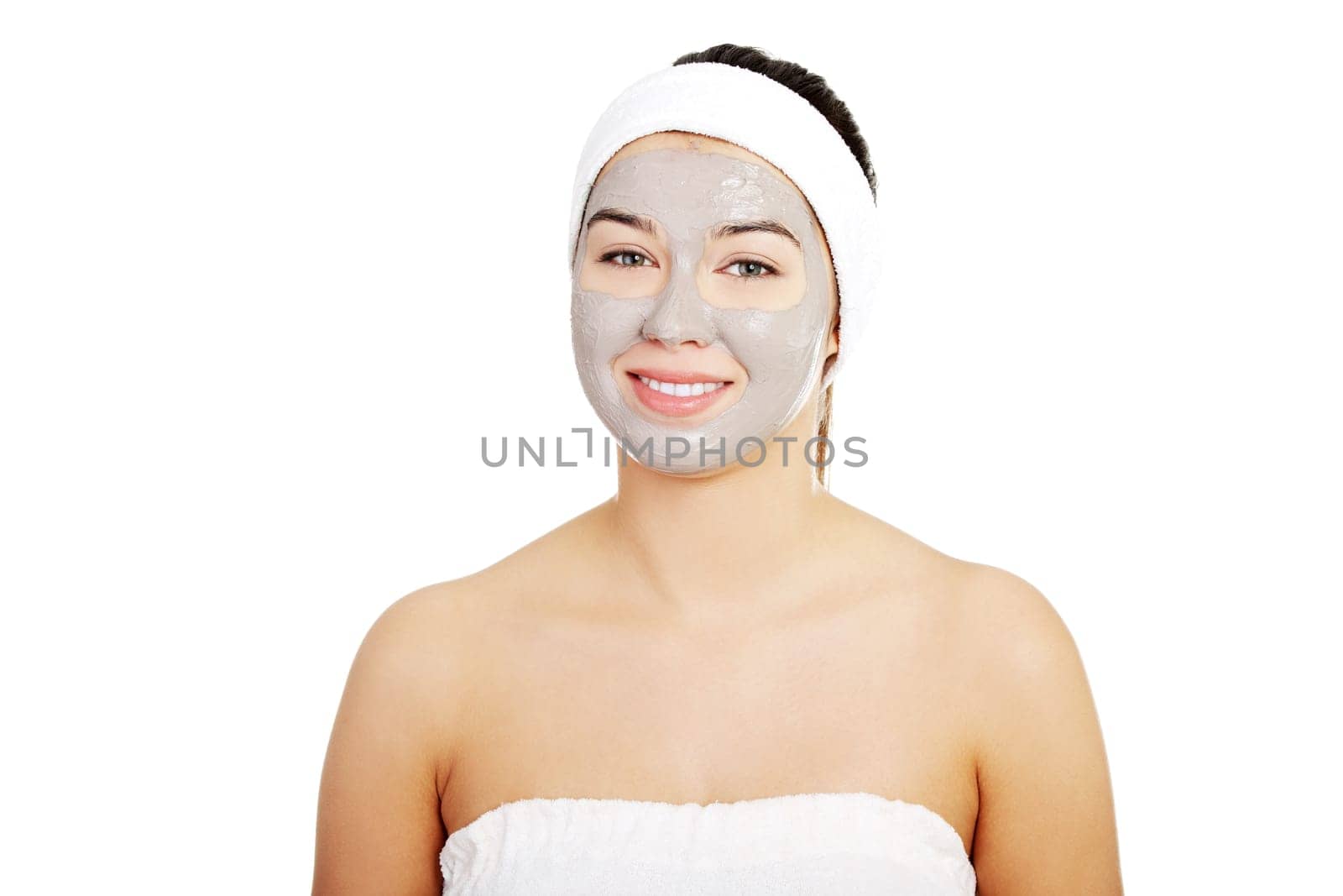 Beautiful woman with clay facial mask, isolated on white