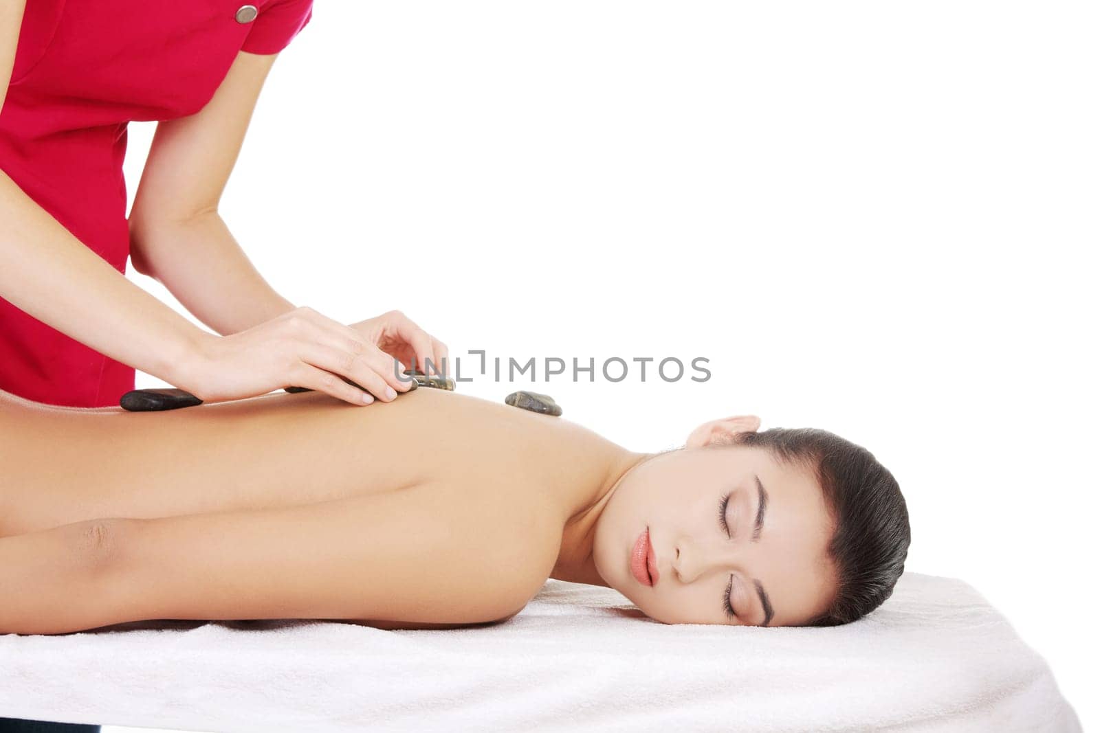 Beauty woman relaxing in spa. Stone massage.