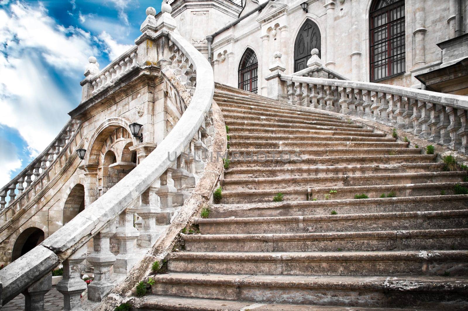Beautiful ancient grand stairway of the church with blue cloudy sky in background (Bykovo, Russia)