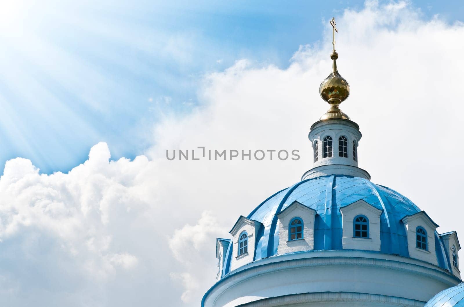 Blue dome of beautiful old russian church with cloudy sky in background