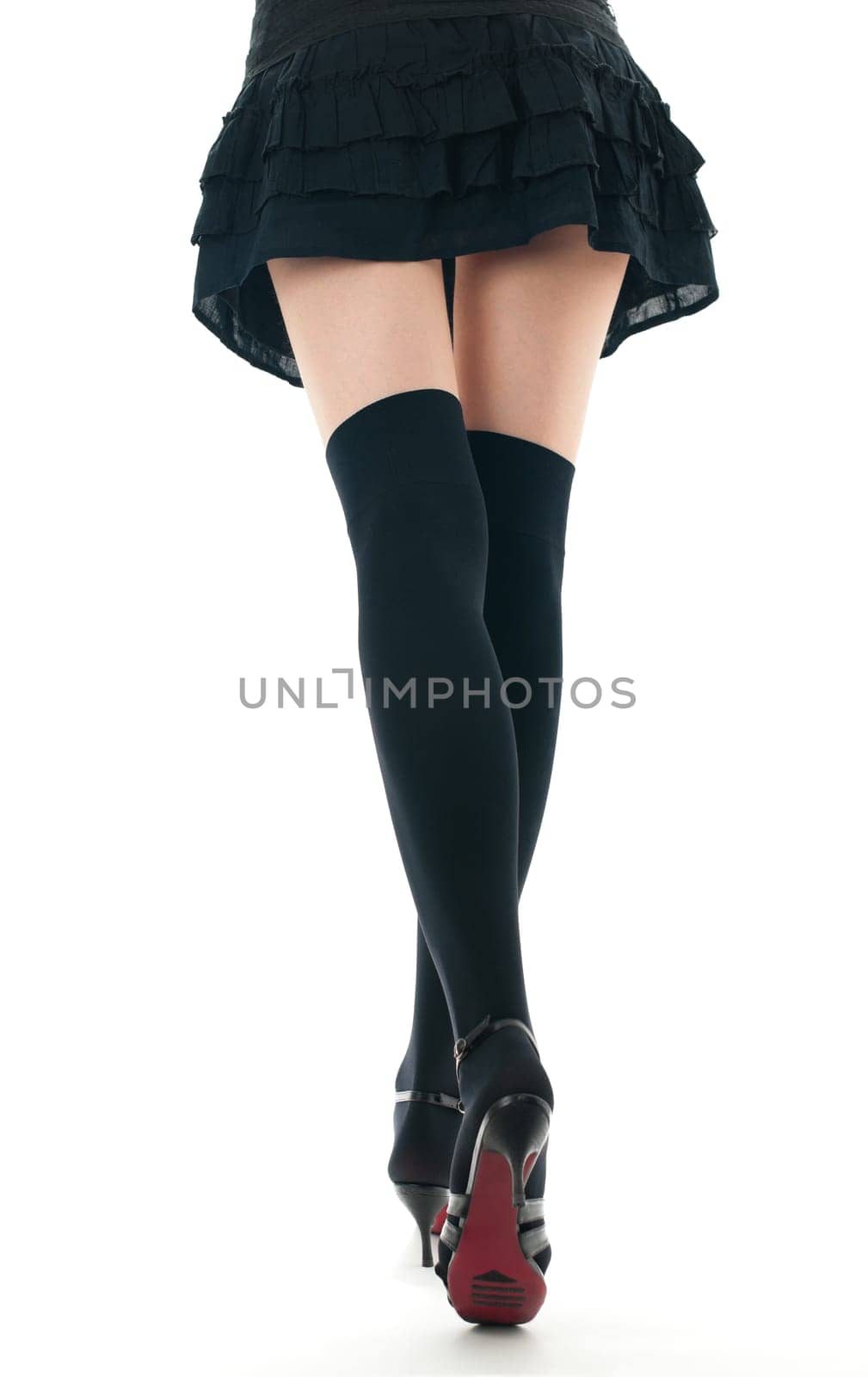 view of the lower body part isolated on white background of woman wearing skirt, stockings and high heels