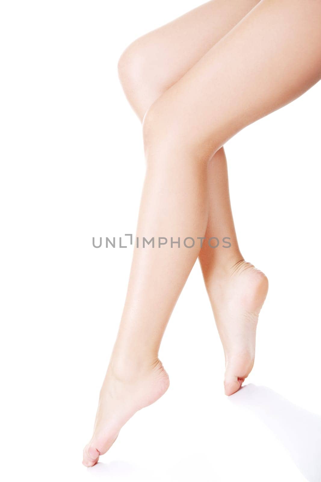 Beautiful fit long female legs, isolated on white