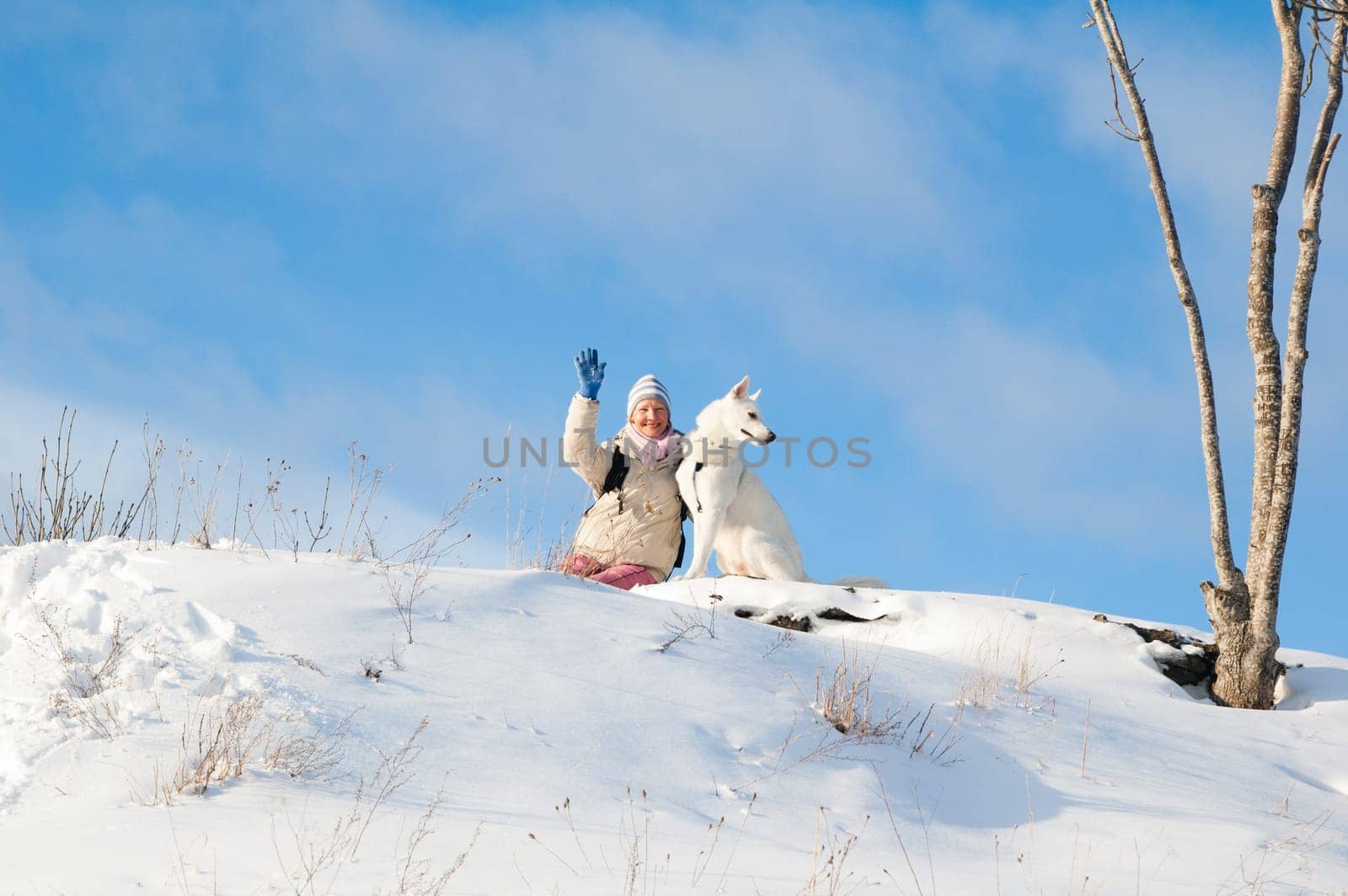The woman with a dog in winter on walk