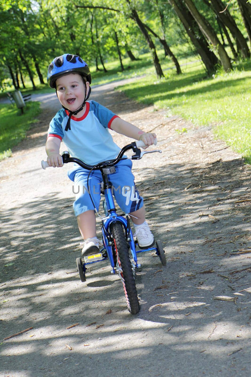 joy game on child bicycle in spring in park