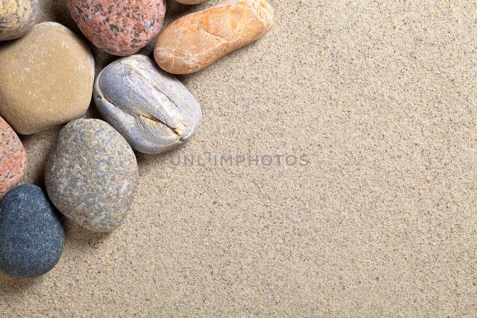 Stones on sandy beach background. Pebbles texture. Macro shot