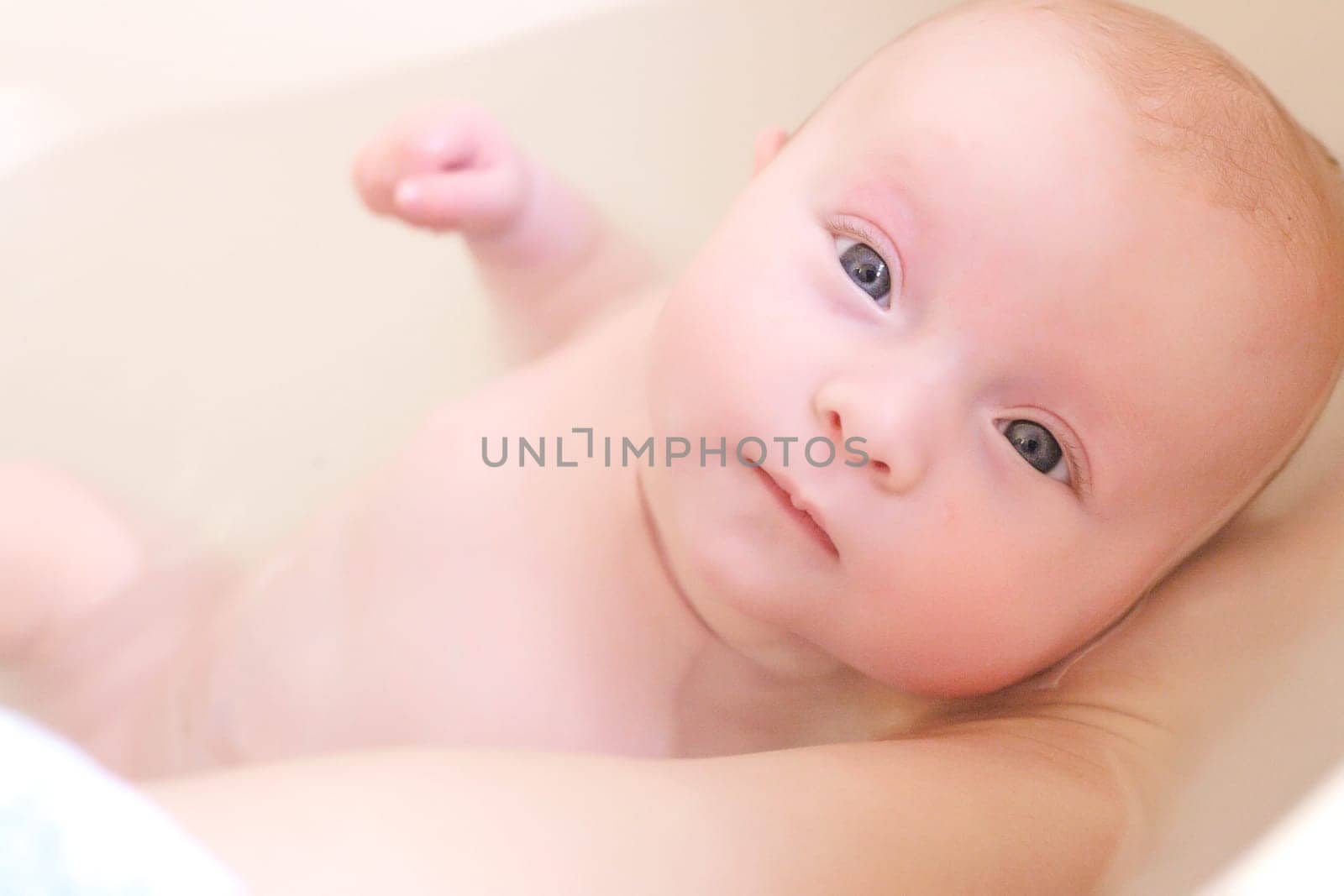 Little baby is having a nice time in bath