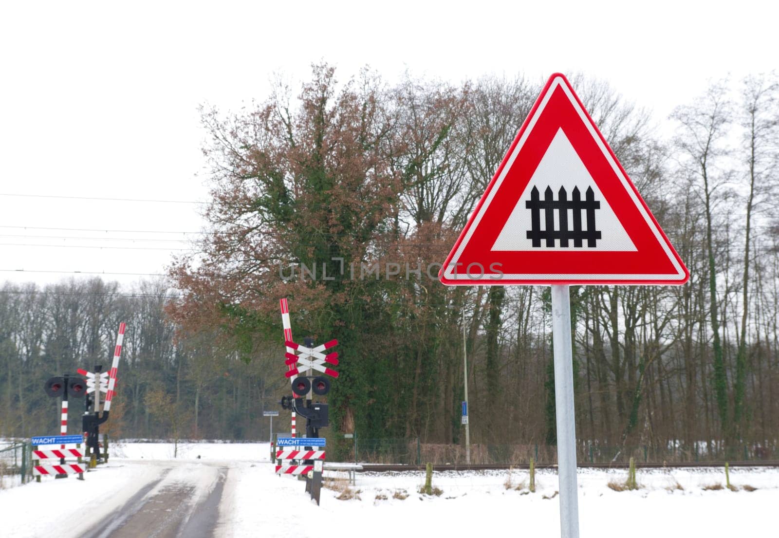traffic sign approaching a railroad secured with automatic gate