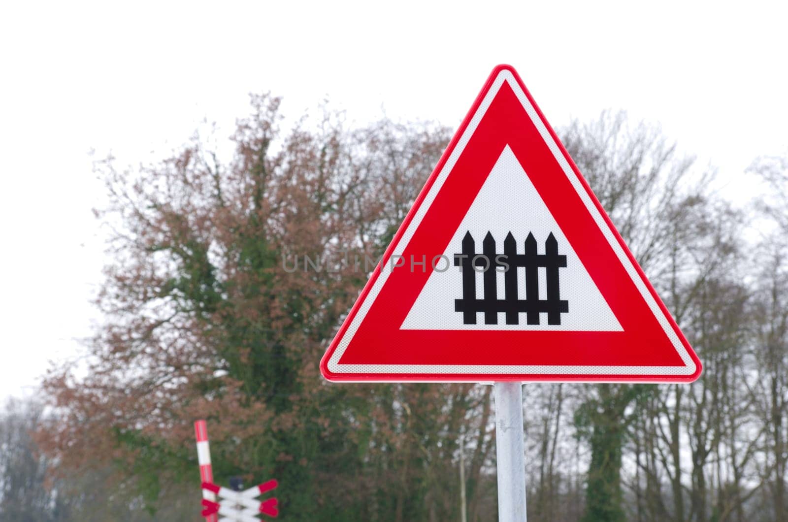 traffic sign approaching a railroad secured with automatic gate