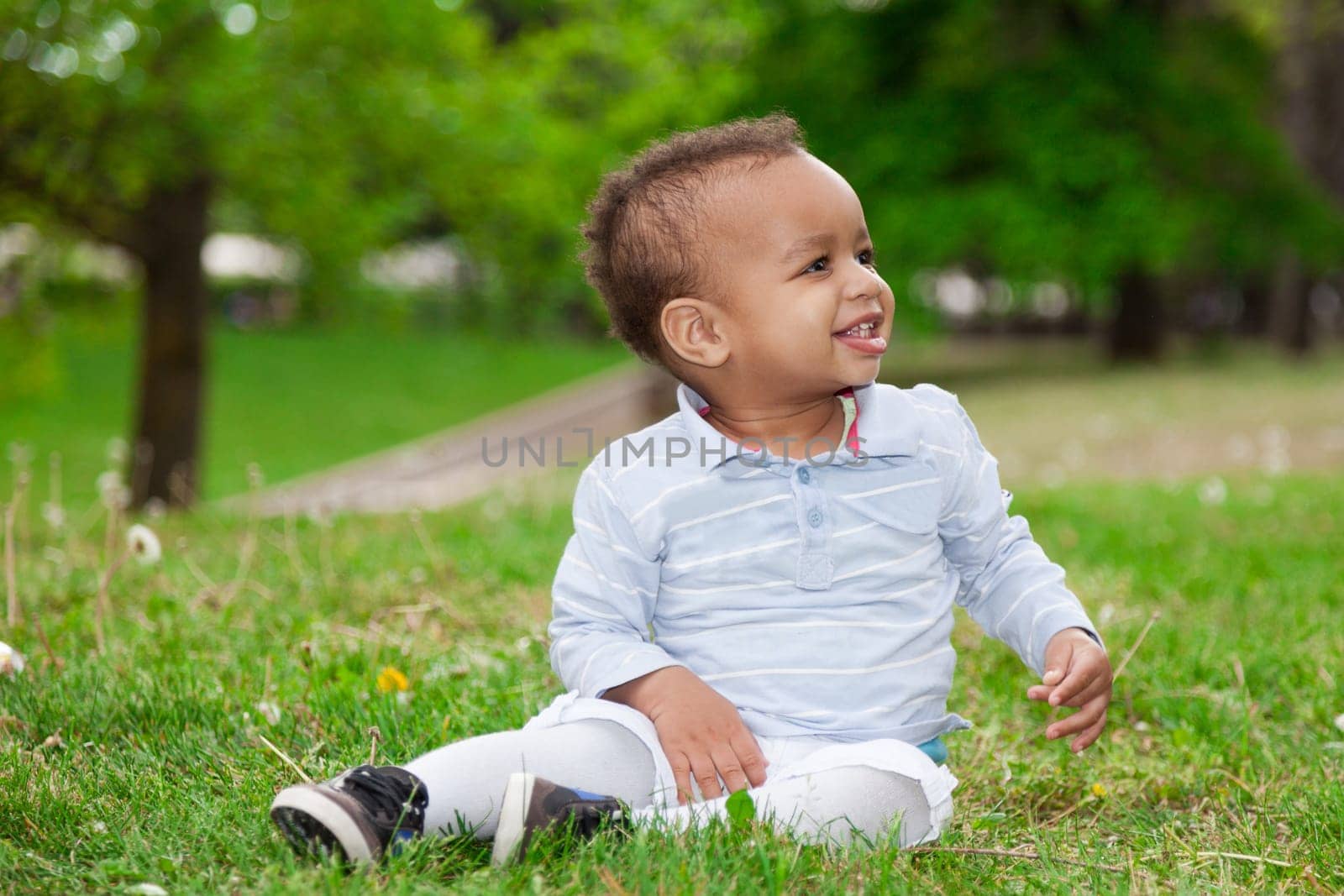 Portrait of a black african american baby boy playing  in the park - African children
