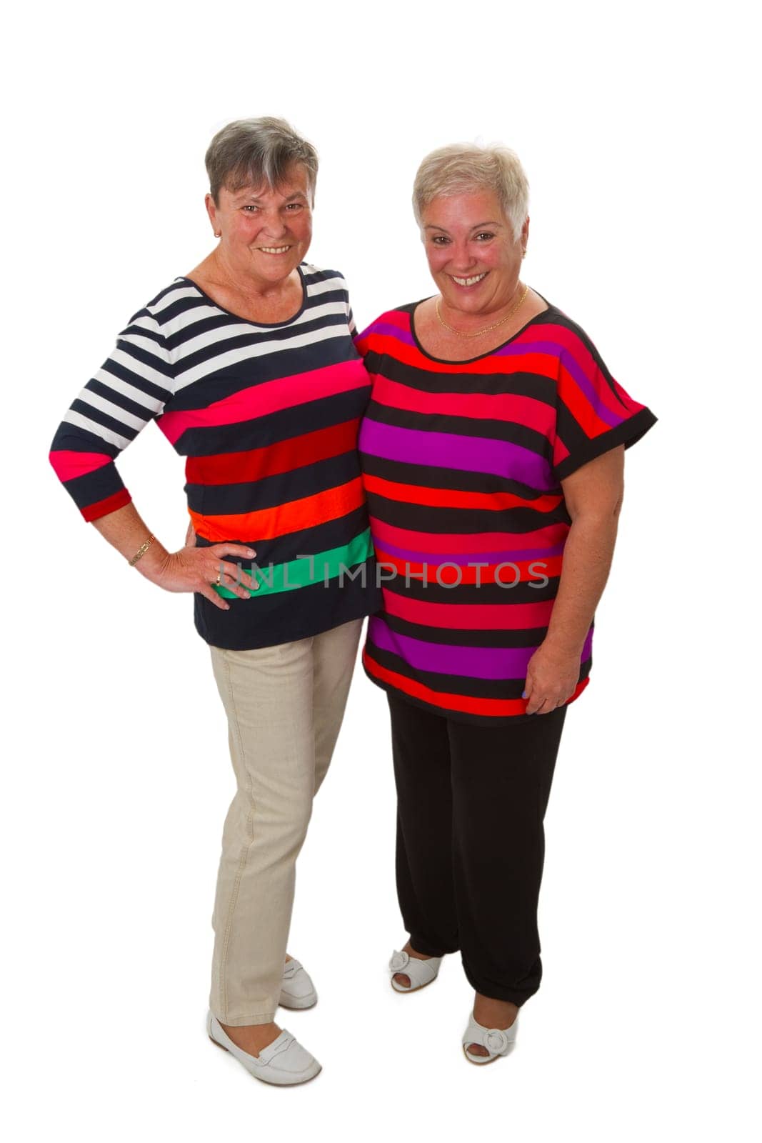 Two senior women standing - isolated on white background