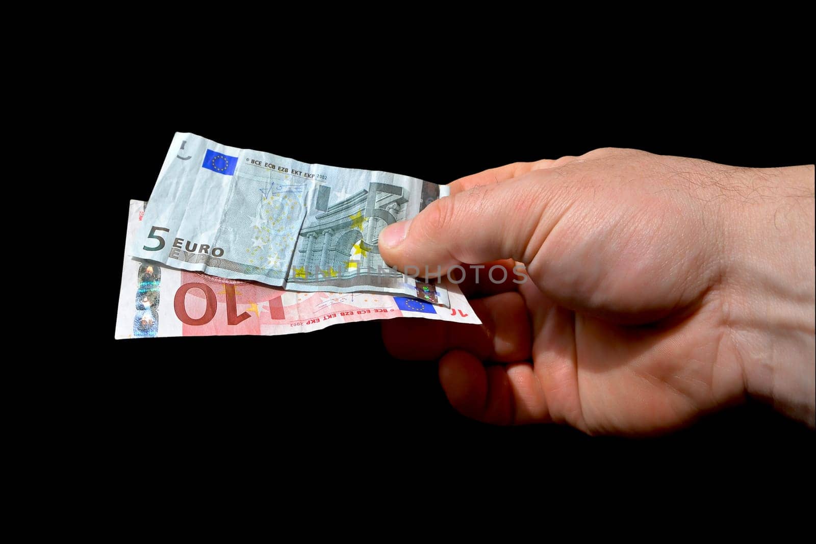 a hand with banknotes to pay for