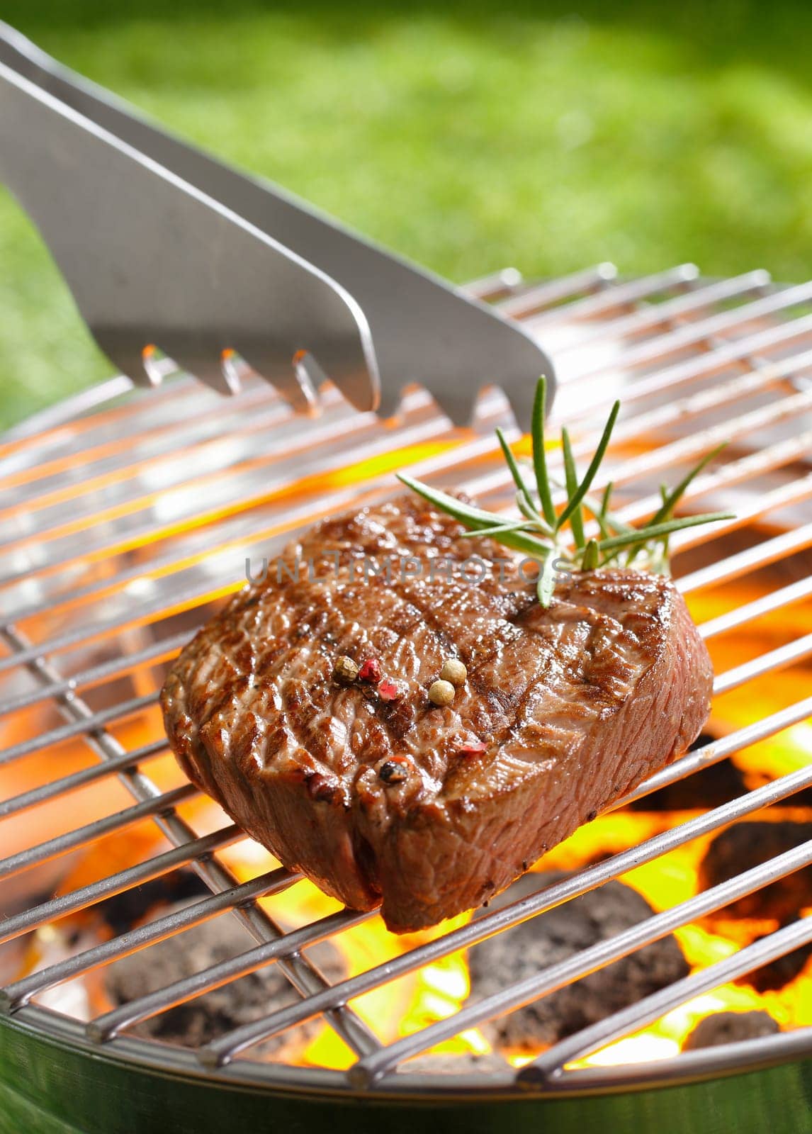 Grilled steak and tong on the grilling pan
