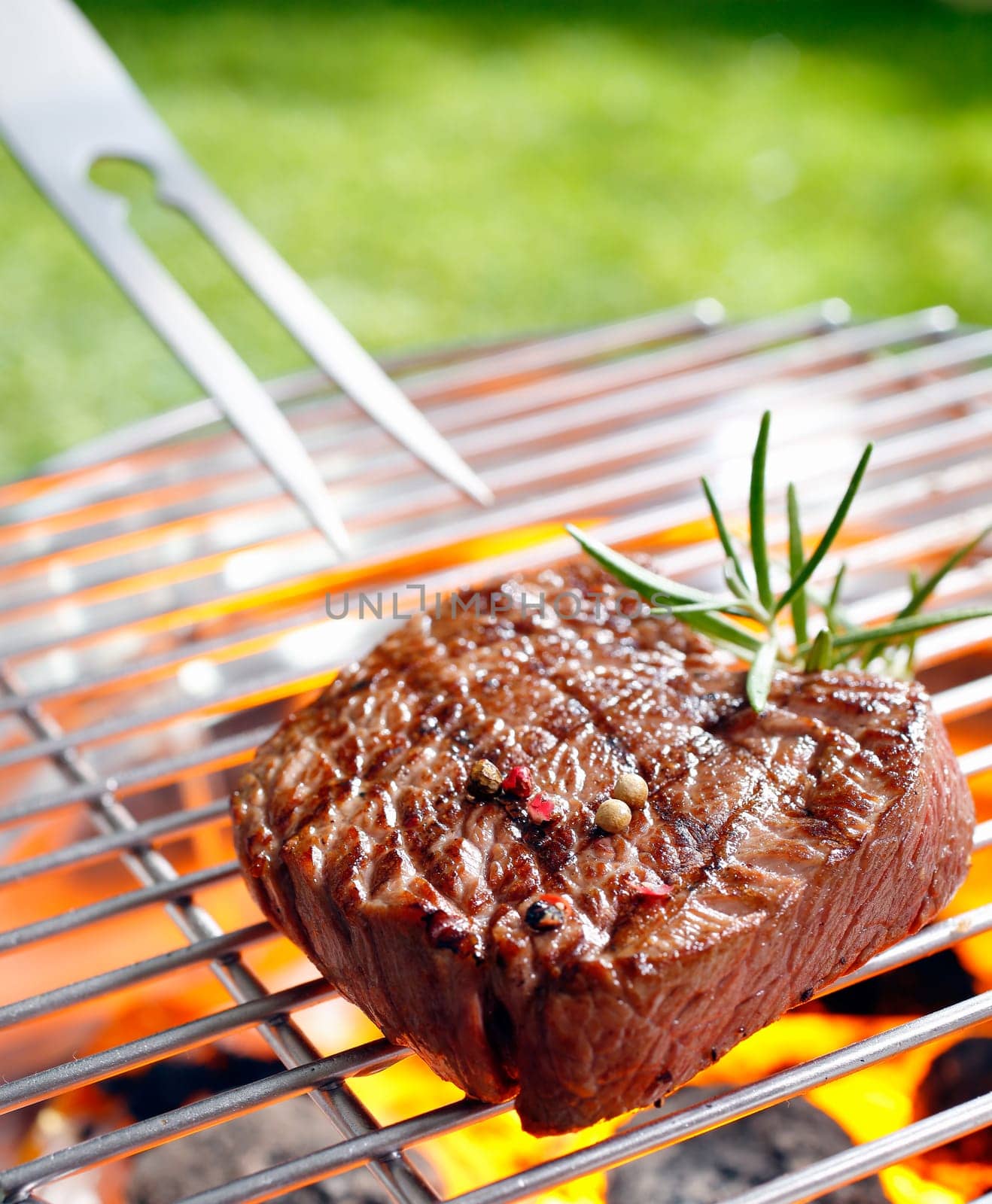 Grilled beef steak on the grilling pan outdoors