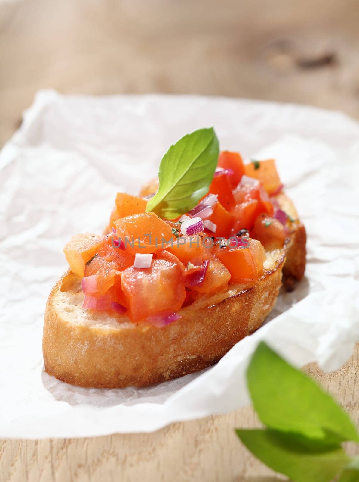 Delicious Italian bruschetta, an antipasti where a variety of toppings are put on toasted or grilled bread, in this instance a mixture of chopped tomato, onion, oil and seasonings on toasted baguette