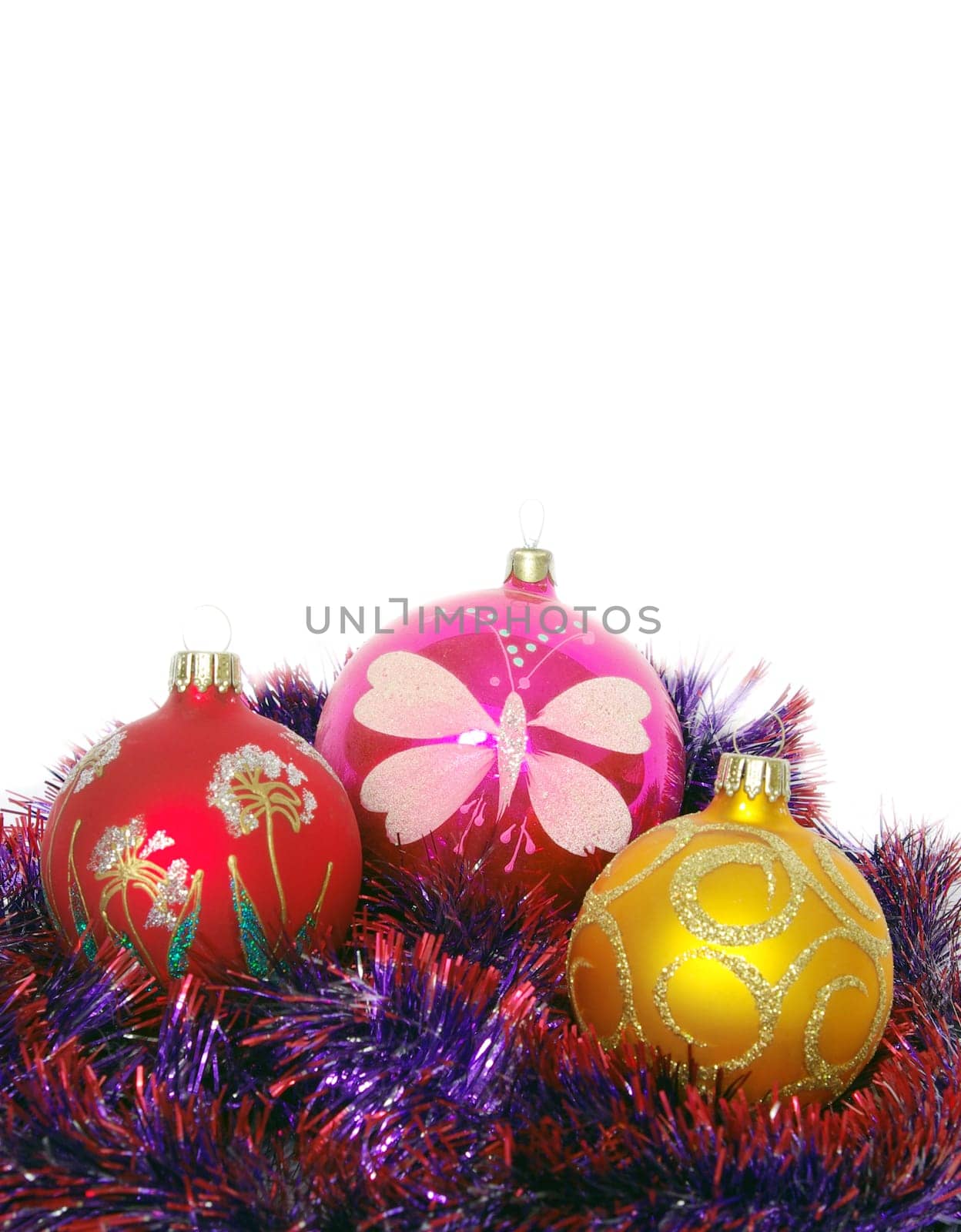 Christmas tinsel and toys on a white background