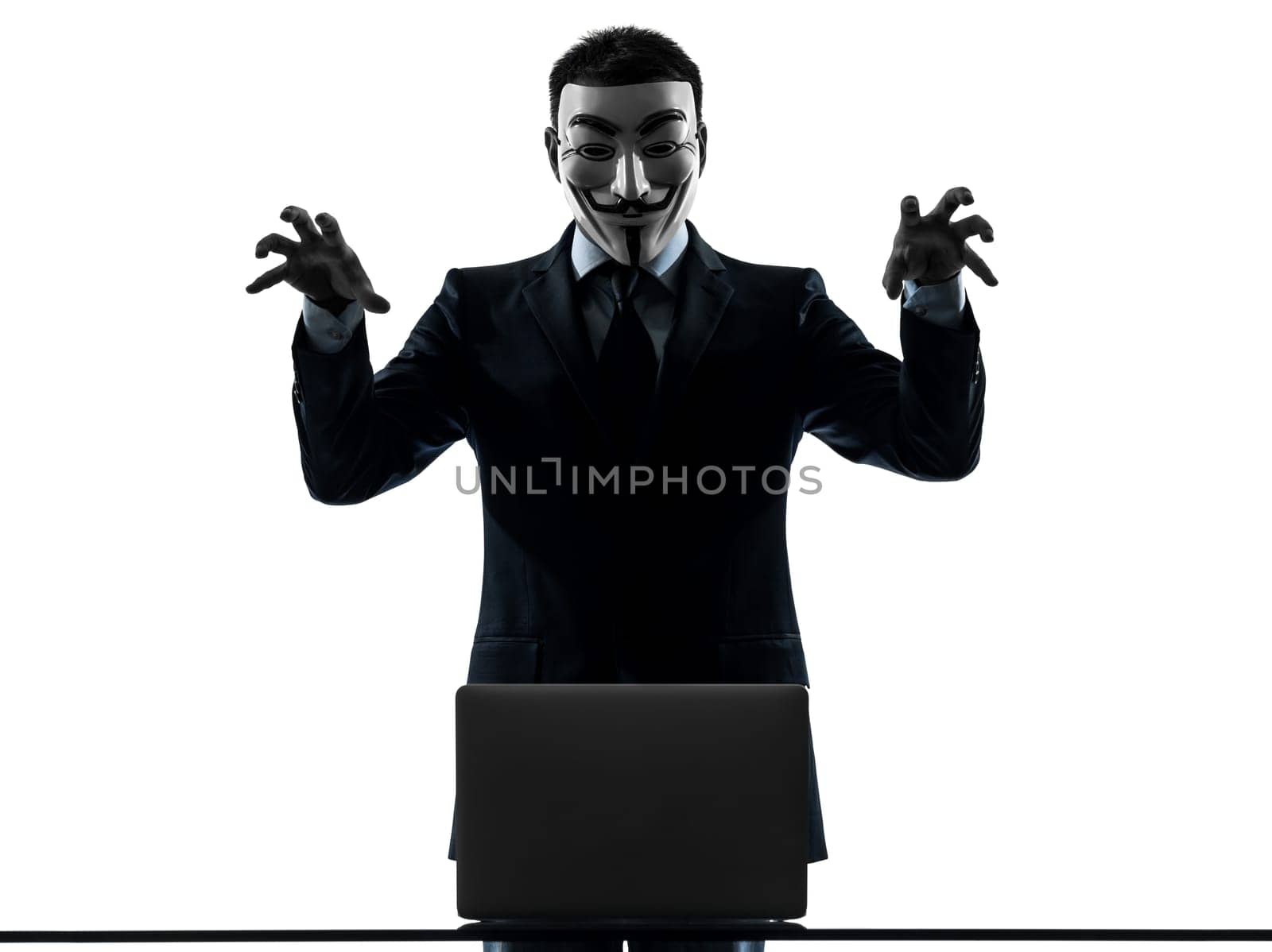 PARIS– OCTOBER 30 : one man dressed and masked as a  member of Anonymous underground group member computing computer menacing on October 30, 2012 in Paris ,France